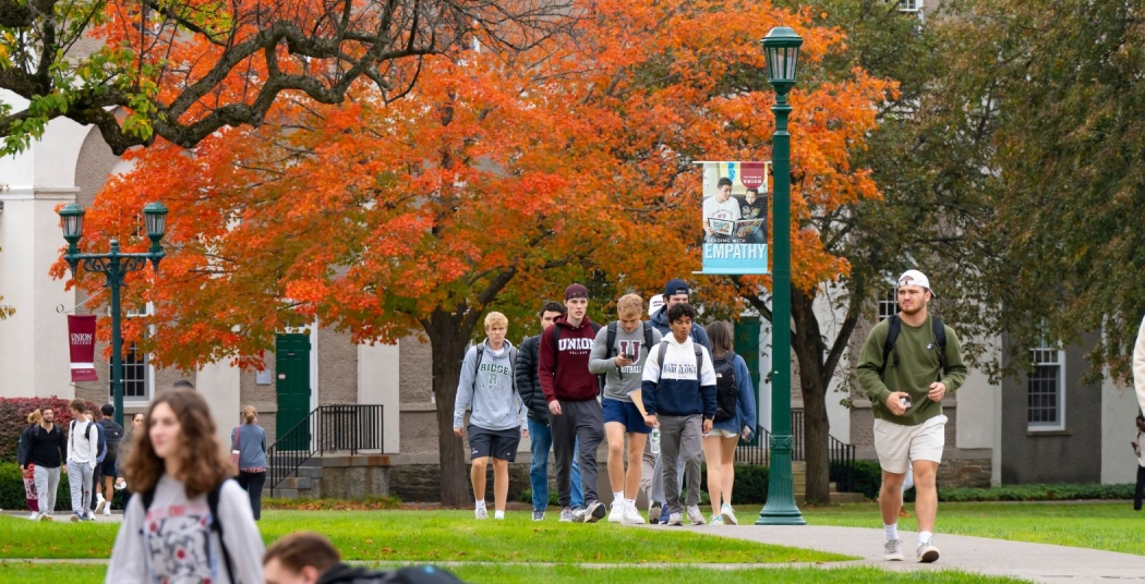 Students walking on campus in the fall. 