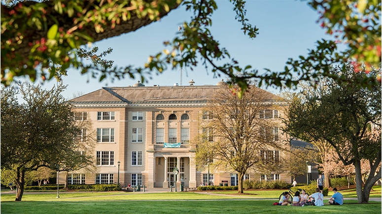 Exterior of Reamer Campus Center with students sitting on the lawn