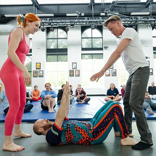 Charles Batson performs stunts with performers in Henle Dance Pavilion