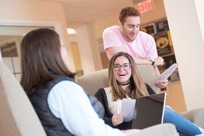 Students engaged in some friendly conversation in a Karp Hall hallway