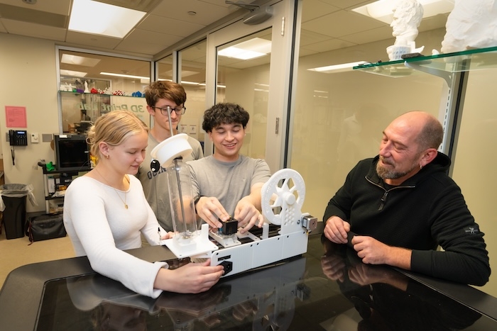 On a recent weekday afternoon, Olivia Belfonti ’27, Michael Fitzmaurice ’27 and Adam Otsuka ’27, examine a pultrusion machine in Union’s 3D lab on the ground floor of the Wold Center.