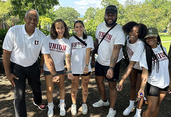 President Harris and students show off their Garnet Chargers tattoos