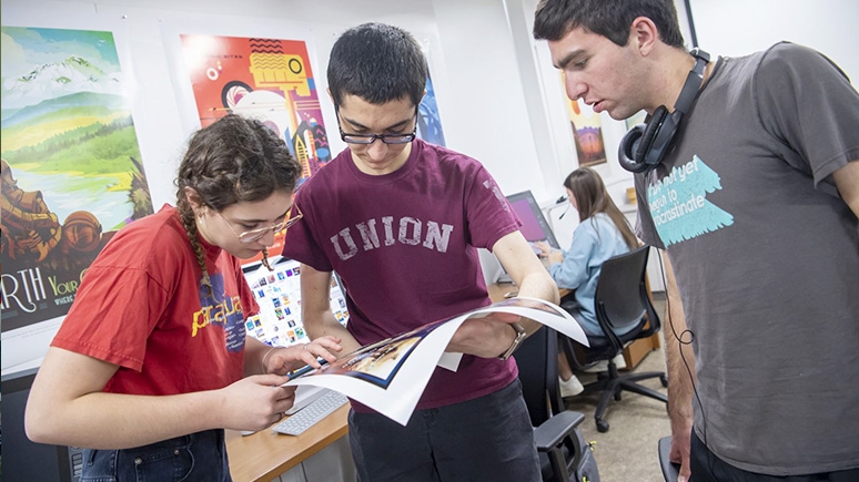 Students studying an artistic print