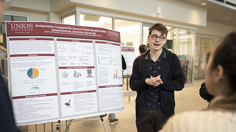 A student presents his research in the Steinmetz Symposium poster session