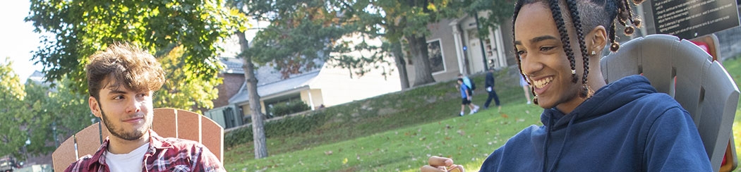 Two students enjoy some conversation outside