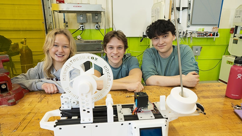 Students pose with an environmetal water filter of their own design