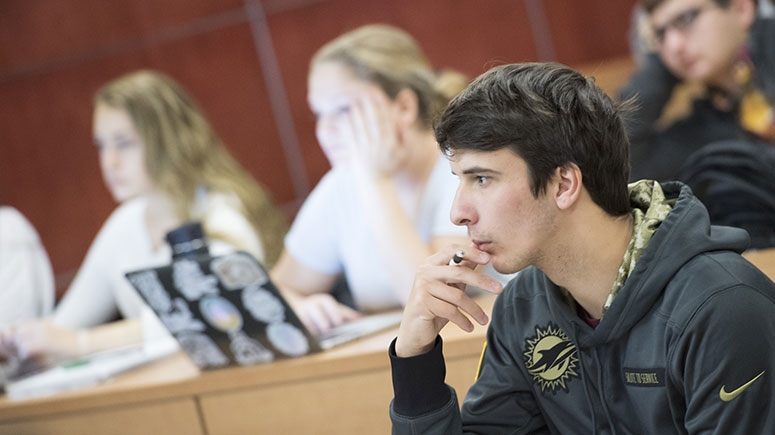  A student listens closely during a political science class at the college.