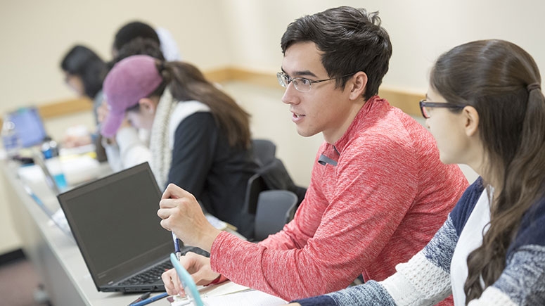 Students seated in a sociology class talking to one another