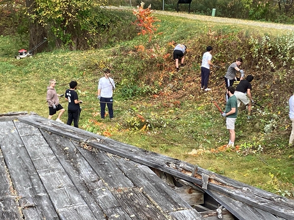 Students work on restoring the Erie Canal Lock 23 historic site in Rotterdam, N.Y.  in fall 2023.